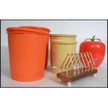 A group of retro mid 20th century items to include 4 1960s Tupperware storage containers in orange
