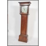A 19th century long case grandfather clock having an oak trunk having a columned hood with gilded