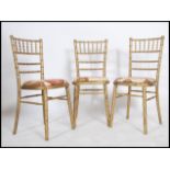 A set of 4 20th century gilt bamboo dining chairs. The chairs with chintz upholstered pad seats