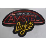 A retro  20th century neon style Amstel Beer advertising light box sign havin faux neon style front.