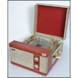 A vintage mid 20th century two tone Pilot Encore portable record player. Fitted with a four speed