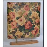 A vintage retro mid century chintzy floral fire screen with a built in back lit electrical light.