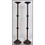 A pair of Victorian tall oak eclesiastical candle stick stands / prickers having raised on