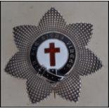 A silver  hallmarked star shaped Masonic Brooch  surrounding an enamelled centre with inscription