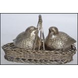 A silver plated table salt and pepper cruet set in the form of nesting birds the wicker work nest