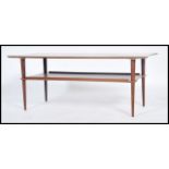 A 1970's Danish influence teak wood coffee table of rectangular form being raised on corner tapering