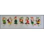 A vintage style cast iron Snow White Disney style coat rack. Each dwarf being hand painted with hook