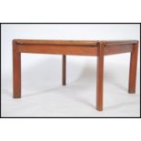 A 1970's Tarn Stole Danish teak wood coffee table of square form being raised on chamfered edge