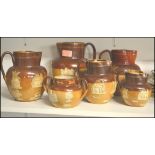 A good group of early 20th century Royal Doulton harvest wear jugs of graduating size along with a