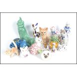 A collection of ceramic cats to include a Devon Studio Zalmen cart, A Sylvac cat group inside a boot