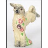 A 1930's Clarice Cliff for Newport Potteries model of a leaping spring lamb, with flowers around its