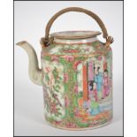 A 20th century Oriental teapot having a wicker handle atop depicting scenes of Geisha's in cartouche