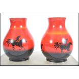 A pair of mid 20th century Sylvac flambe vases in the wild horses pattern of bulbous form being