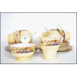 An Aynsley 6 person art deco tea service in a chintzy pattern on a cream background consisting of