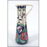 A Moorcroft tall jug, tubelined decorated in the Charles Rennie Mackintosh Tribute pattern, signed