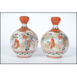 A pair of 19th century Oriental Kutani baluster vases with waisted necks having geometric borders