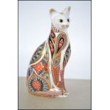 A Royal Crown Derby paperweight in the form of a cat having original gold crown stopper. Measures