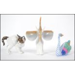 A Rosethall German ceramic cat along with a Hollohaza Hungarian Elephant figurine and a Herend