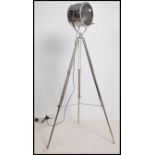 An Andrew Martin polished steel tripod lamp. The l