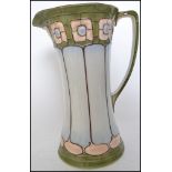 A Victorian Art Nouveau jug of tapering form decor