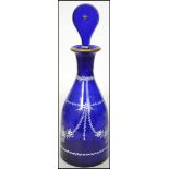 An early 20th century blue glass decanter having a
