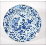 An 18th century delft bowl charger in blue and whi