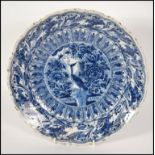 An 18th century delft charger bowl in blue and whi