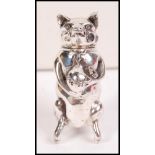 A silver gentleman's vesta case in the form of an upright seated pig having a hinged top head with