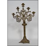 A 19th century French ecclesiastical five arm candelabra raised on a hexagonal pierced base with