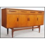 A 1970's G-Plan kelso teak wood sideboard of Danish influence having short drawers and cupboards