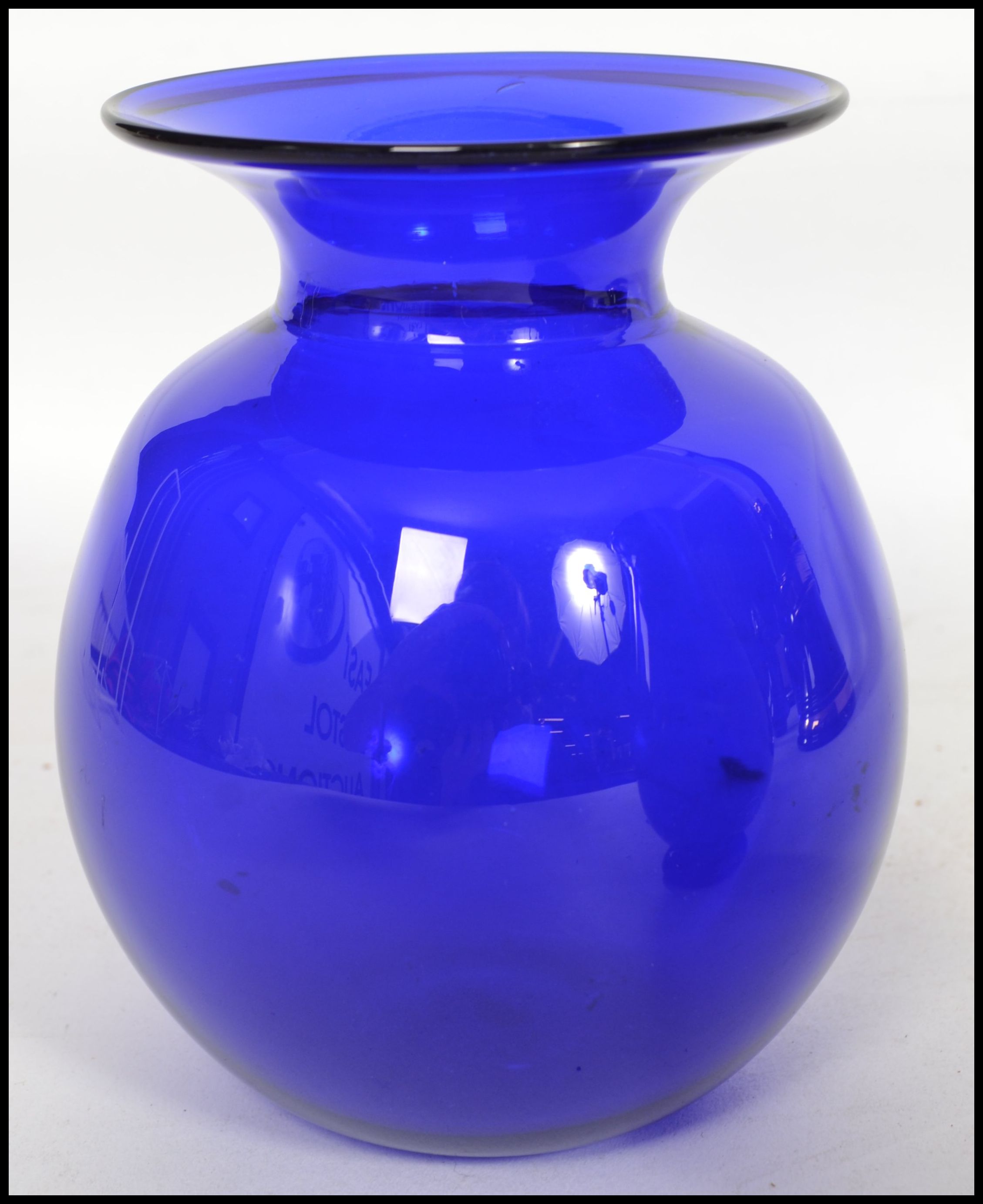 A group of 20th studio art Bristol Blue glass wares to include paperweight, vases, ashtray along