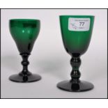 Two 18th century Georgian Bristol green glass wine glasses one raised on a plain foot with knopped