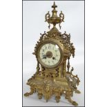 A 19th century brass ormulu 8 day French Empire  mantel clock. The clock with decorative cast