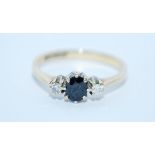 A hallmarked 9ct gold, diamond and sapphire three stone ring. Size M. Weight 1.7g.