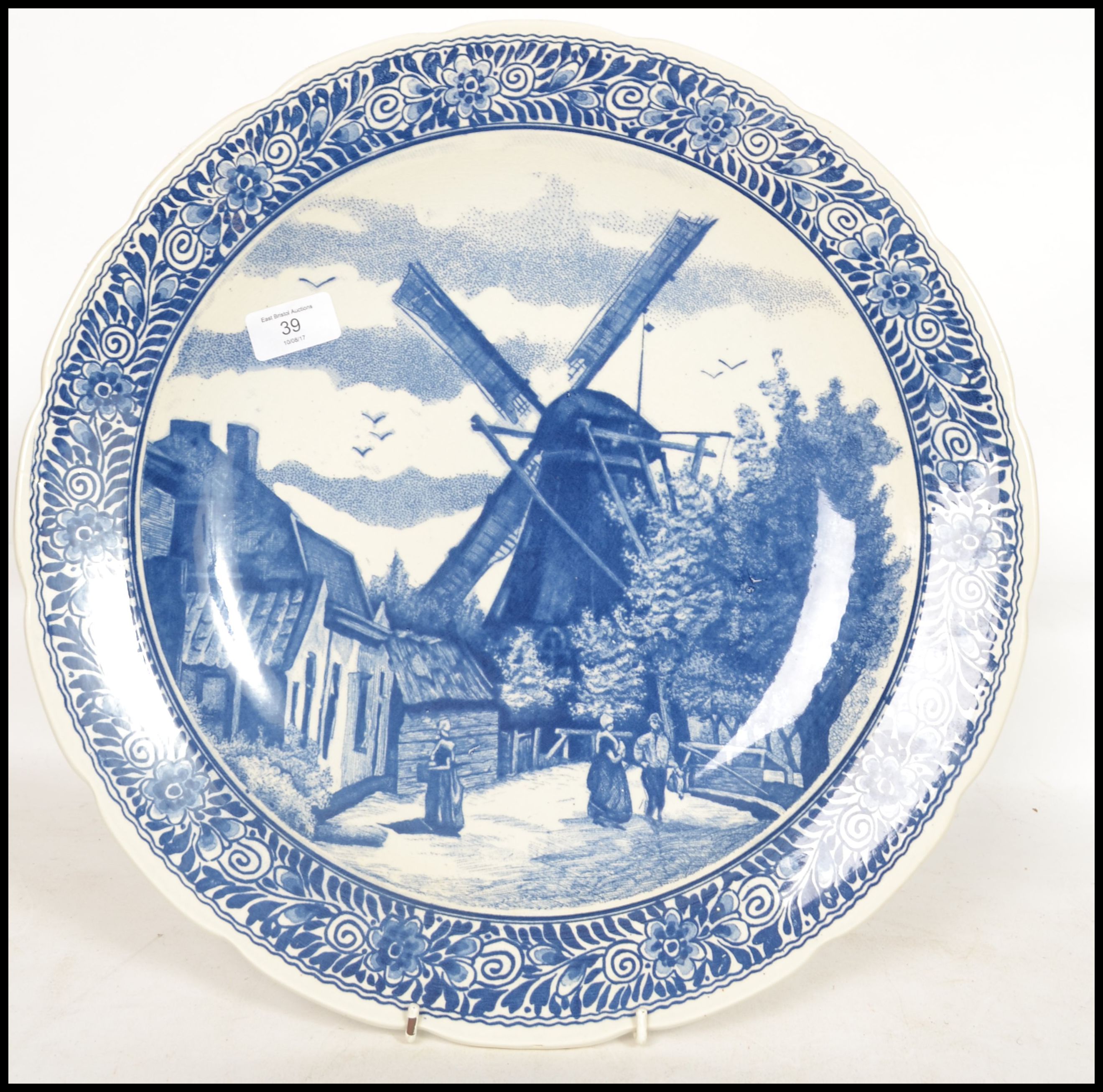 A 20th century Delft ceramic wall hanging charger plate having a central tondo depicting a - Image 2 of 5