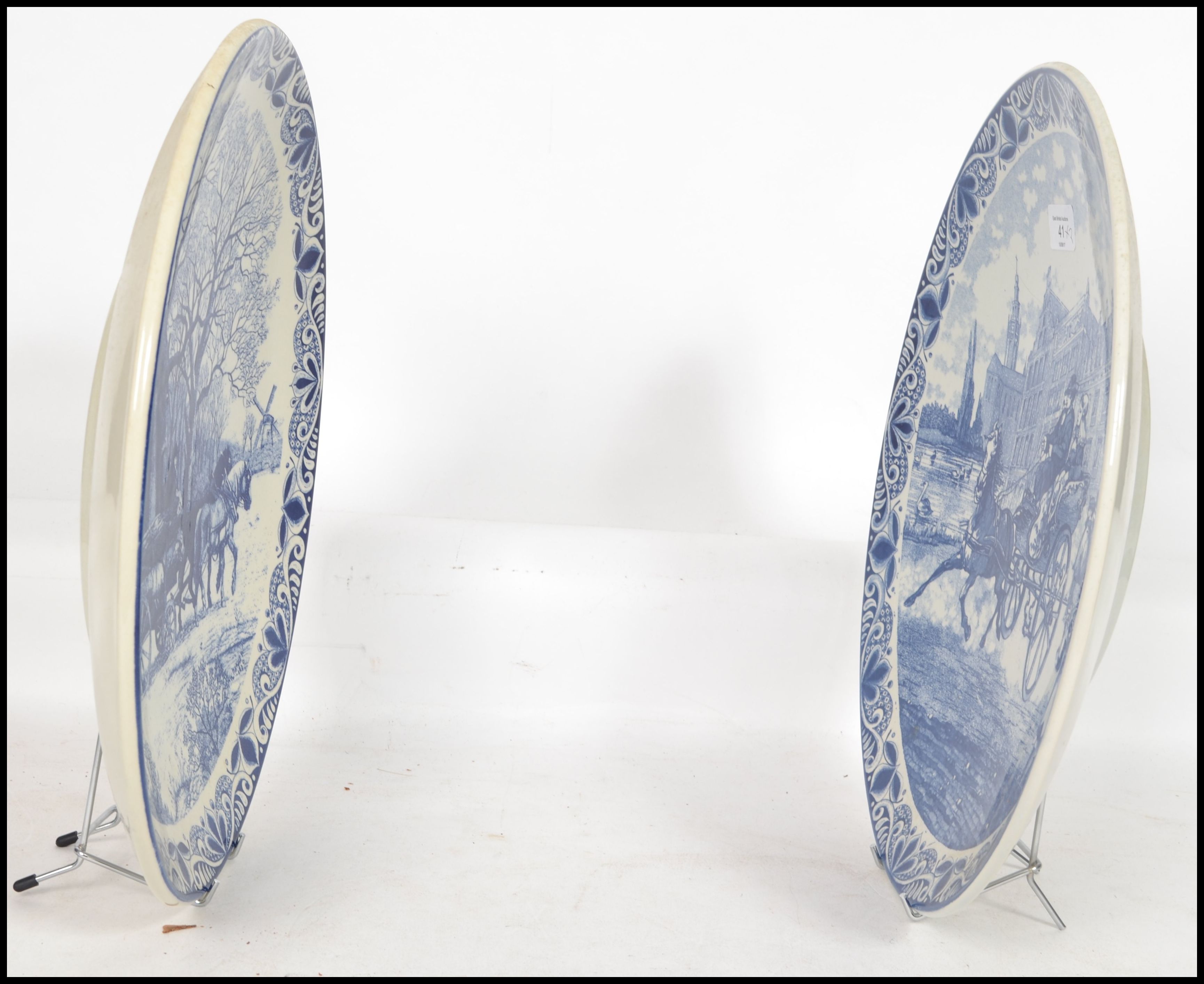 Two 20th century Delft ceramic wall hanging charger plates each having a central tondo depicting - Image 5 of 10