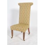 A 19th century Victorian prayer chair raised on castors with turned wood legs to the front and