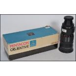 A vintage Pentacon Objektive 4/300 VB M42 X 1 Camera Telephoto Lens complete in the original box.