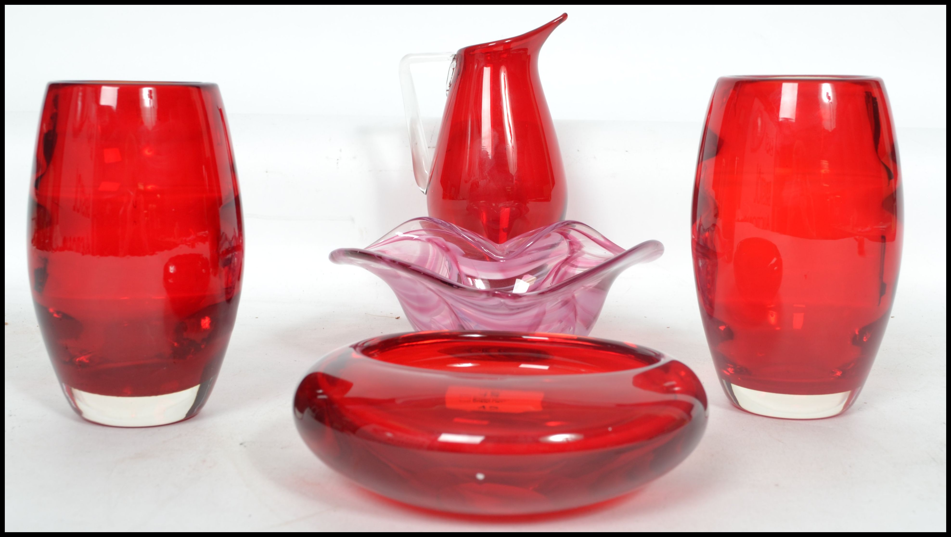 A group of four retro mid 20th century studio art cranberry glass items to include a pair of small