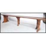 An exceptional pair of 19th century French fruitwood polished refectory pig benches. Each with