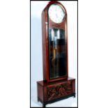 A 20th century large German free standing grandfather clock by Moathe / Mauthe raised on a large
