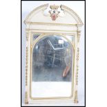 A large over-mantel 19th century painted mirror having a swan neck pediment with a central painted