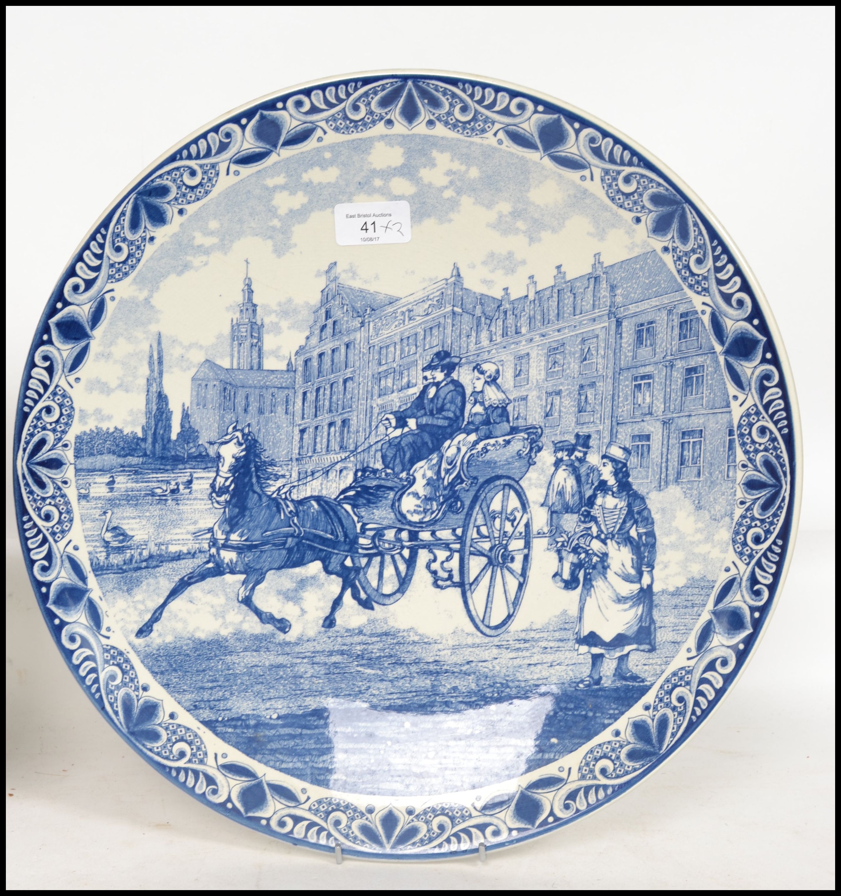 Two 20th century Delft ceramic wall hanging charger plates each having a central tondo depicting - Image 4 of 10