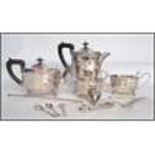 A four piece Sheffield silver plate tea service having ebonised handles along with a collection of