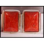 A pair of silver and apple coral clip on earrings complete in the presentation case.