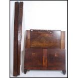 A 1930's Art Deco walnut single bed having tall panel headboard with embellished details complete
