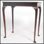 An early 20th century mahogany side / lamp table raised on cabriole legs with pad feet having a