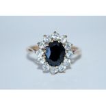 A hallmarked 9ct gold sapphire and white stone cluster ring. Hallmarked Birmingham. Size M. Weight