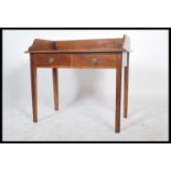 A Victorian mahogany writing table desk being raised on squared legs with twin drawers to the