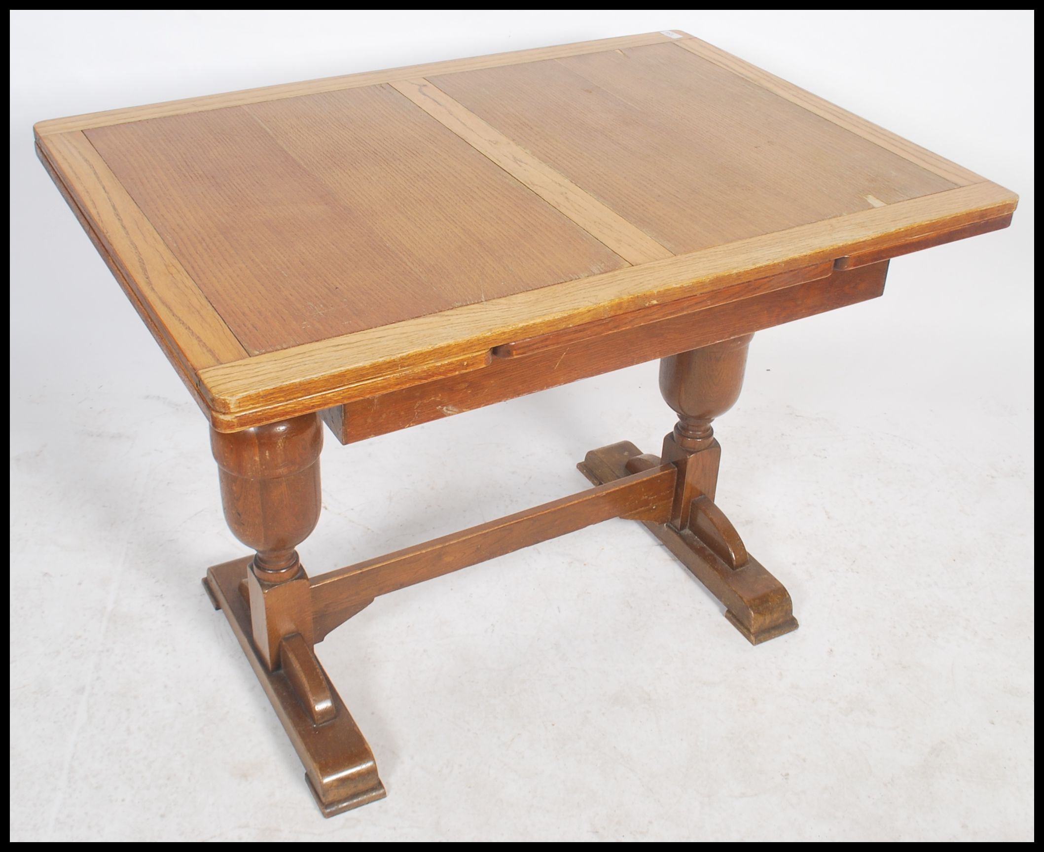 A 1930's oak draw leaf refectory dining table raised on turned legs united by stretcher having - Image 2 of 4